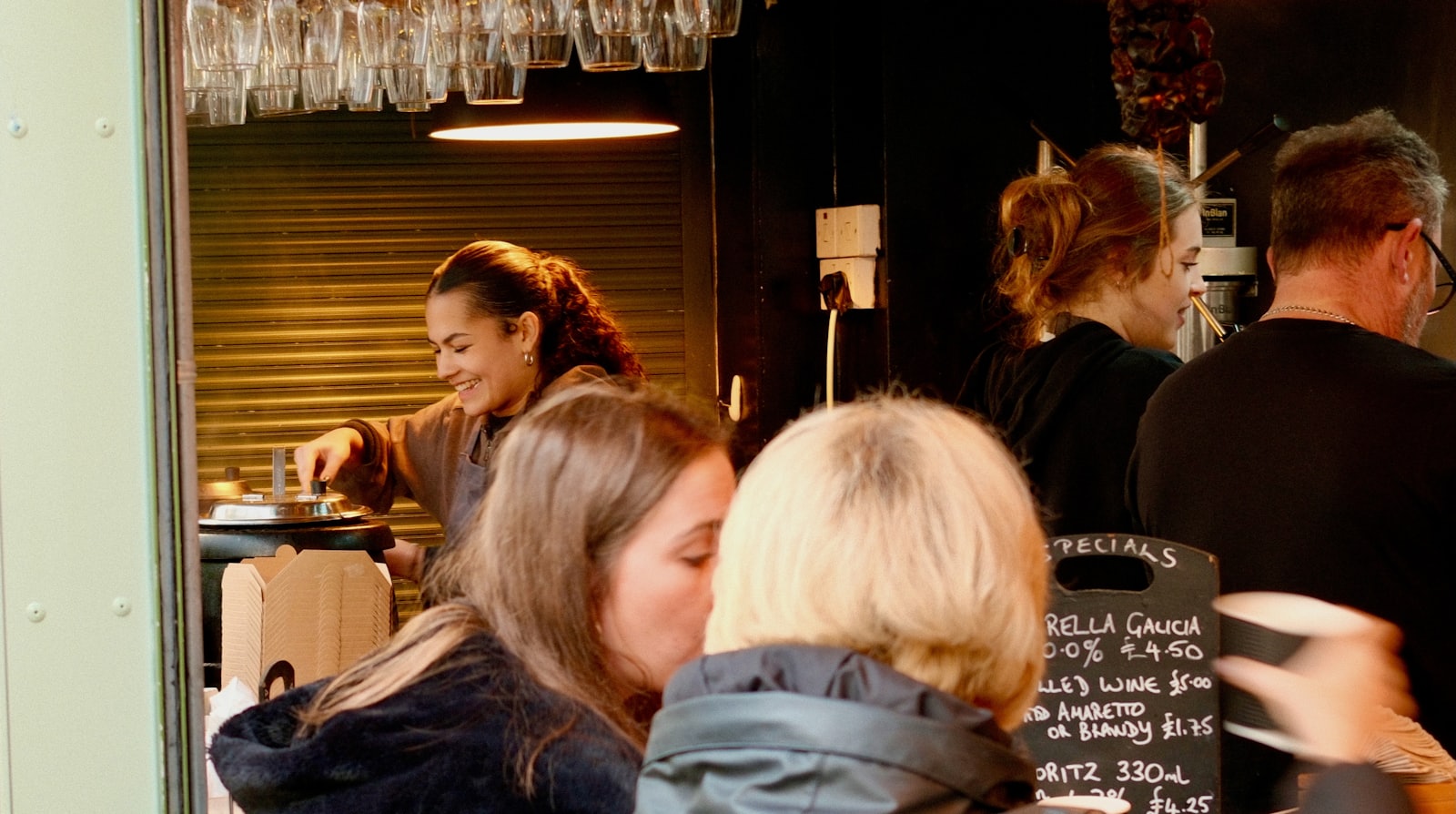People enjoying drinks and conversation in a busy cafe