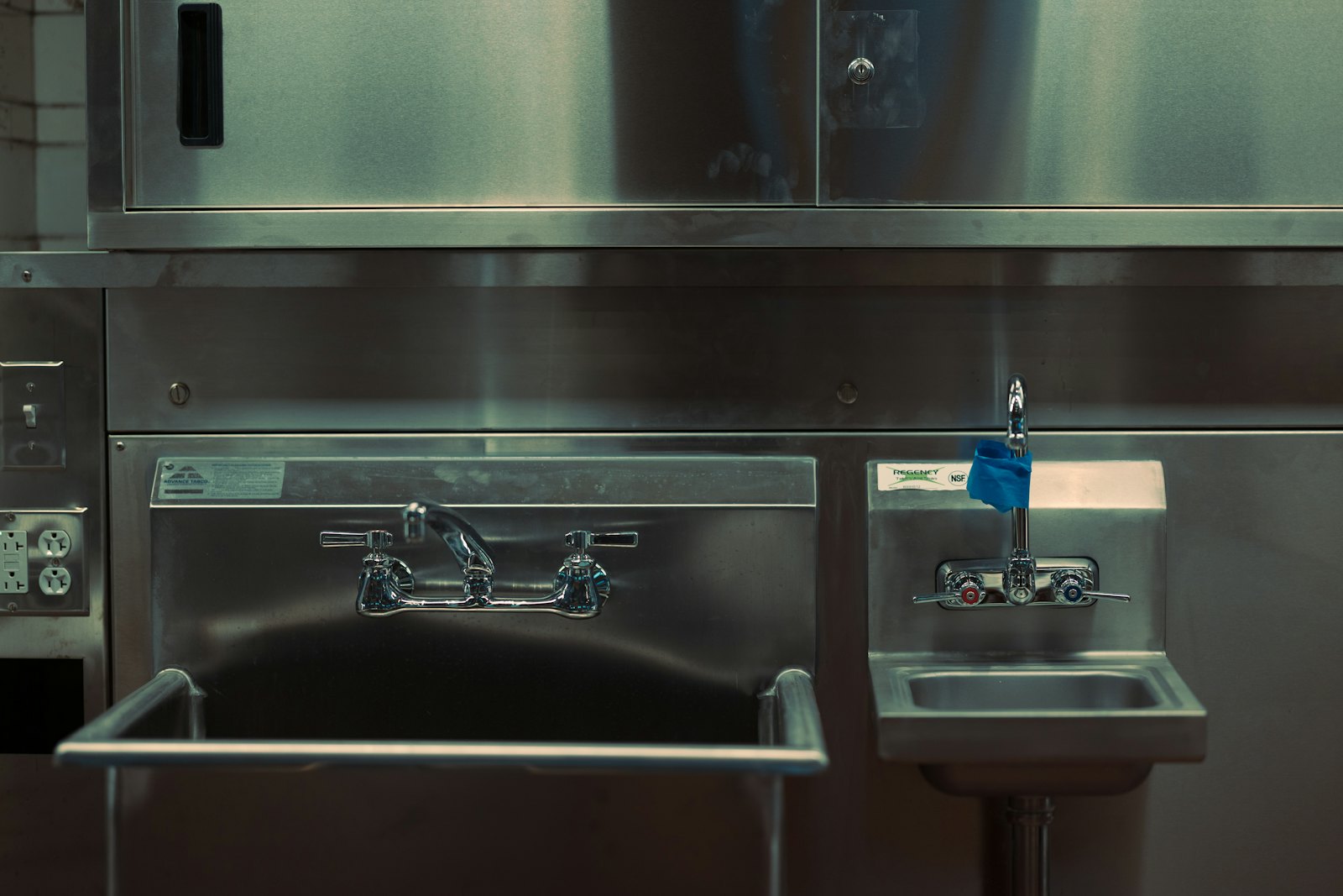 A stainless steel kitchen with a sink and oven