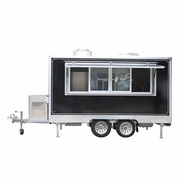 Long twin axle catering trailer with a full length service window and its folding legs down.